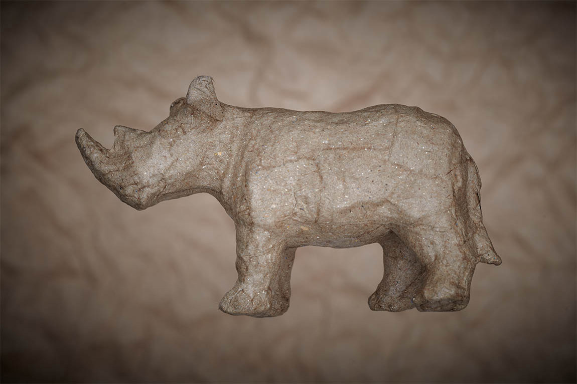 Paper rhino on paper background