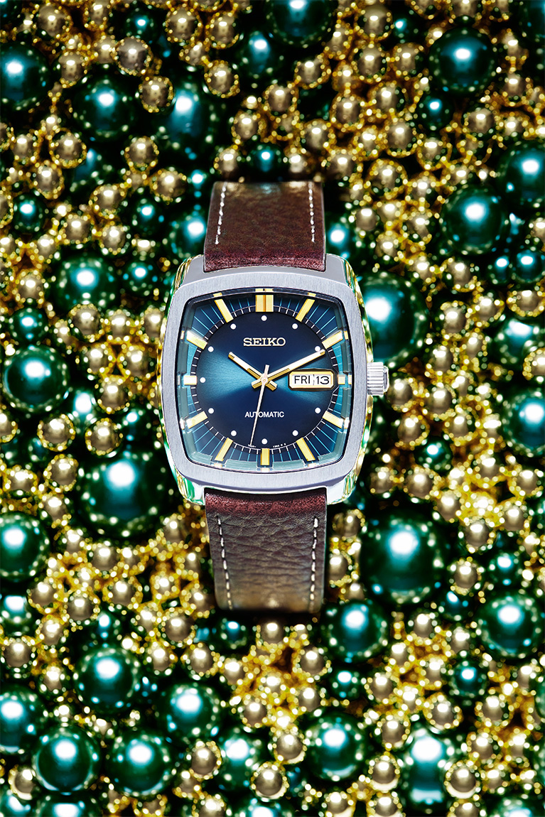 Seiko wristwatch product photography on gold and green